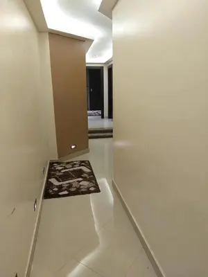 a room with a hallway with a door and a rug at Full sky apartment in Irbid
