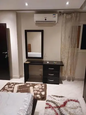 a bedroom with a dresser with a mirror and a television at Full sky apartment in Irbid