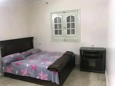 a bedroom with a bed and a tv at المناخير هوستل in Amman