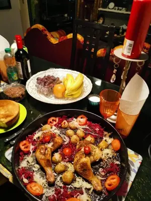 a table with a pan of food on a table at المناخير هوستل in Amman