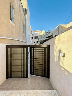 a garage door with a dog painted on the side of a building at Beit Ahlan Suites 7 in Amman