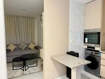 a small kitchen and living room in a apartment at Beit Ahlan Suites 7 in Amman