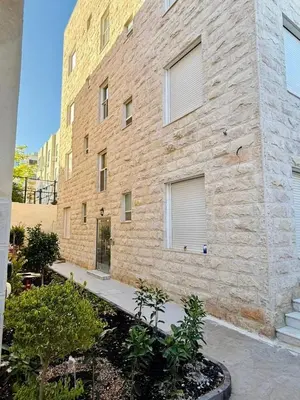 a brick building with windows on the side of it at Beit Ahlan Suites 7 in Amman