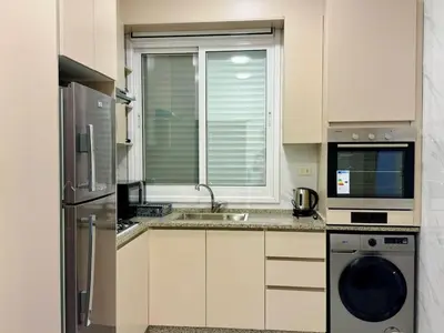 a kitchen with a sink and a dishwasher at Beit Ahlan Suites 8 in Amman