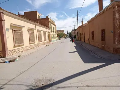 an empty street in a town with buildings at 10 seasoun House in Dawqarah