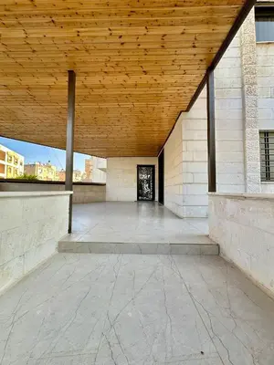 an empty patio with a wooden ceiling at Modern Residence for families only in Amman
