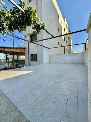 an empty parking lot in front of a building at Modern Residence for families only in Amman
