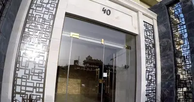 a glass door to a building with a sign on it at Apartment in Amman 7th Circle near Cozmo market in Amman