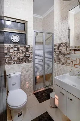a bathroom with a toilet and a shower and a sink at Apartment in Amman 7th Circle near Cozmo market in Amman