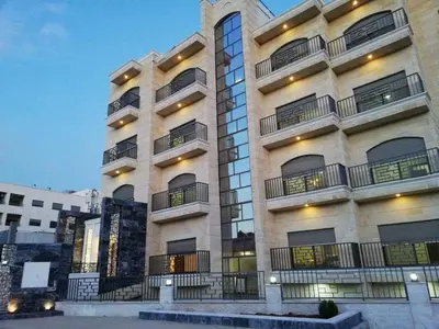 a large building with balconies on the side of it at Apartment in Amman 7th Circle near Cozmo market in Amman