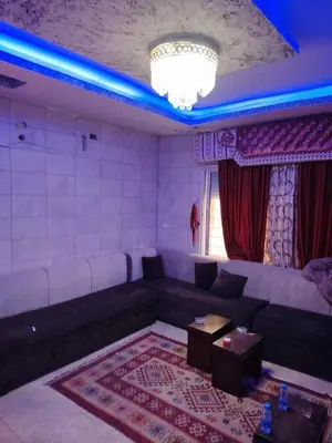 a living room with a couch and a table at mraco apartment in Amman
