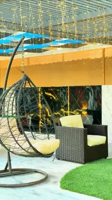 a swinging chair in front of a building at Ras Al Khaimah Farm & Resort
