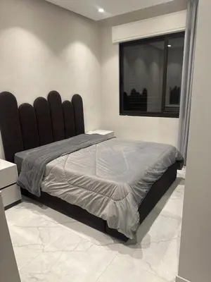 a bedroom with a large bed with a large window at Apartment in dergbar in Amman