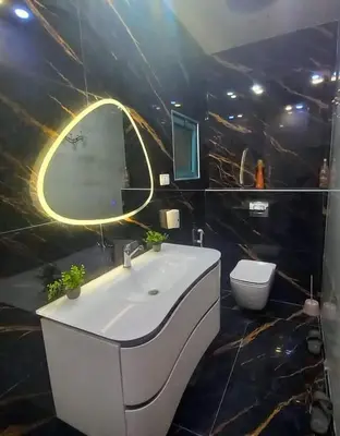 a bathroom with a white sink and a toilet at Amman Central Elegant Apartment in Amman
