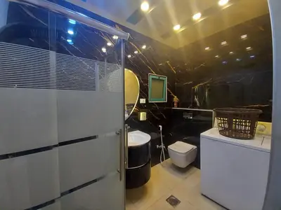 a bathroom with a shower and a toilet and a sink at Amman Central Elegant Apartment in Amman