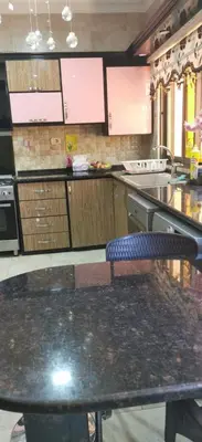 a kitchen with a table with a chair in it at A large, fully furnished Apartment in Amman