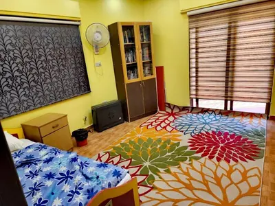 a bedroom with a bed and a colorful carpet at A large, fully furnished Apartment in Amman