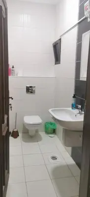 a white bathroom with a sink and a toilet at A large, fully furnished Apartment in Amman