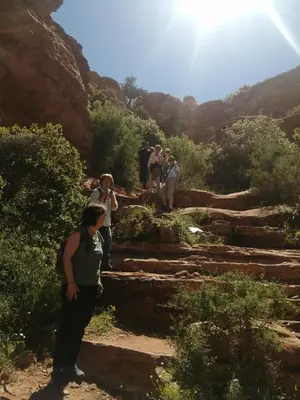 a group of people standing on rocks in a canyon at Friends of Dana Hotel in Dana