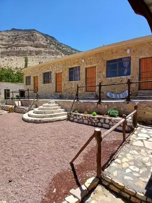 a stone building with steps in front of it at Friends of Dana Hotel in Dana