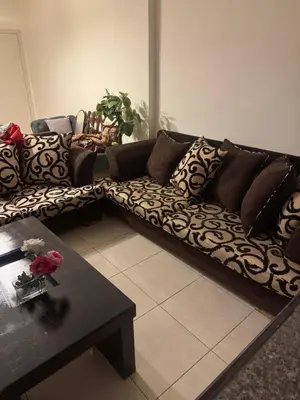 a living room with a couch and a coffee table at الاردن عمان الجاردنز in Amman