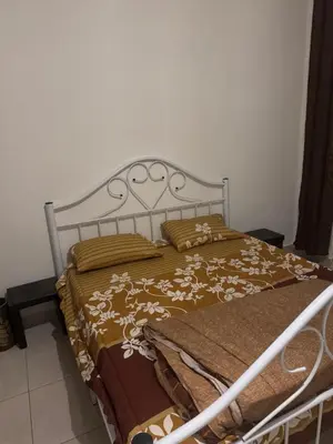 a bed with a metal frame and pillows on it at الاردن عمان الجاردنز in Amman