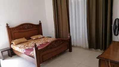 a bedroom with a bed with a wooden frame at الاردن عمان الجاردنز in Amman