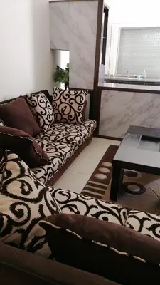a living room with a couch and a table at الاردن عمان الجاردنز in Amman