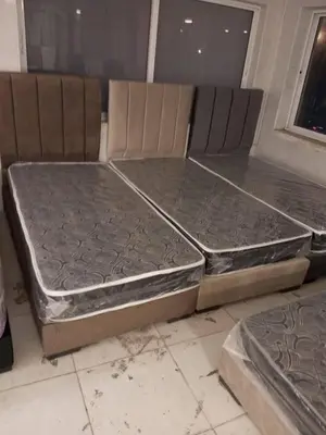 two beds sitting on the floor in a room at العنبق هاوس