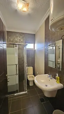 a bathroom with a sink and a toilet and a shower at Private Studio in Amman