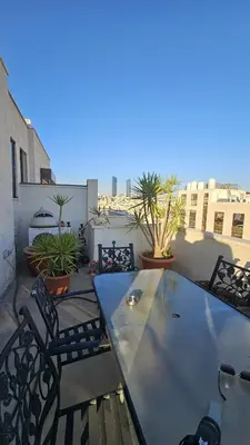 a patio with a table and chairs on a balcony at Private Studio in Amman