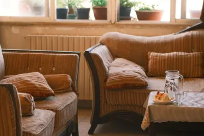 a living room with two couches and a table at Room in central Amman in Amman