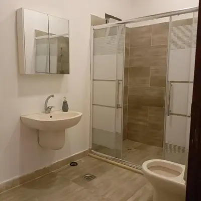 a bathroom with a shower and a sink and a toilet at Chalet Adam- Ajloun شاليه ادم in Ajloun