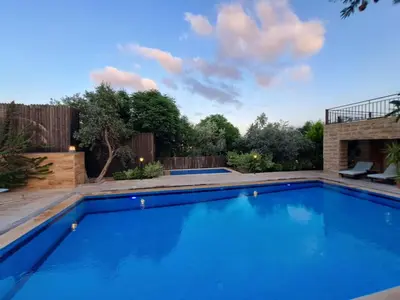 a swimming pool in the backyard of a house at Villa Saya in Jerash