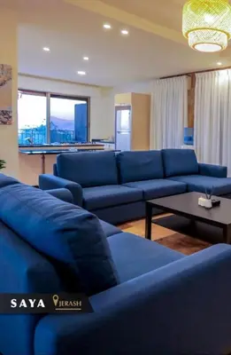 a living room with blue couches and a table at Villa Saya in Jerash