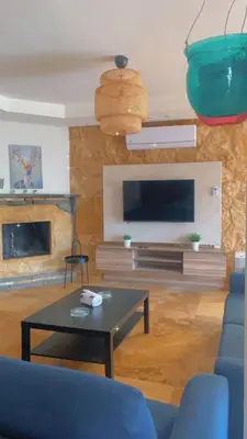 a living room with a couch and a table at Villa Saya in Jerash