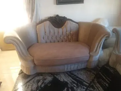 a white couch sitting in a living room at kazami House in At-Tafilah