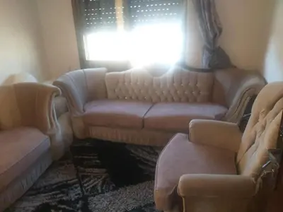 a living room with a couch and a window at kazami House in At-Tafilah