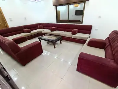 a living room with a couch and a table at kazami House in At-Tafilah