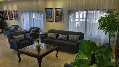 a living room with couches and a coffee table at Black Iris Hotel in Madaba