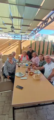 a group of people sitting around a table at Black Iris Hotel in Madaba