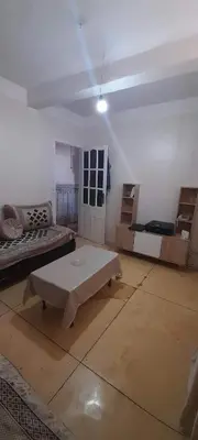 a living room with a couch and a coffee table at Zomik house in Al Qiḩāţī