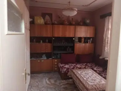 a room with a bed and wooden cabinets at Zomik house in Al Qiḩāţī