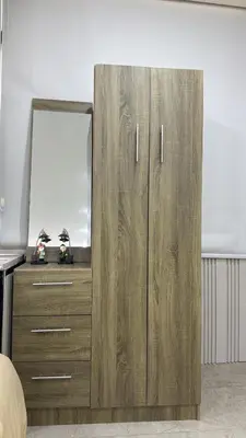 a wooden cabinet with a mirror in a room at sky view rooftop in Amman