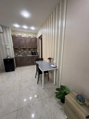 a kitchen with a table and chairs in a room at sky view rooftop in Amman