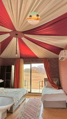 a bedroom with a tent with a bed and a window at RUM fAMILY lUXURY CAMP in Wadi Rum