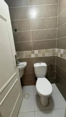 a bathroom with a toilet and a sink at Nargges House in Al Salt