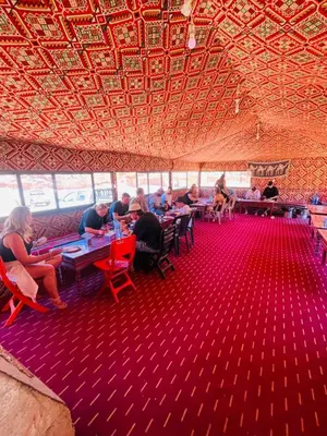 a group of people sitting at tables in a room at saleem with jeep tour in Wadi Rum