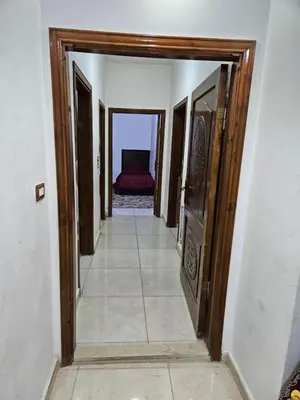 a hallway with a door leading to a bedroom at غصن الزيتون in Ajloun