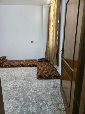 a room with two beds and a door at غصن الزيتون in Ajloun